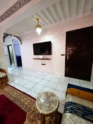a living room with a tv on the wall at Jonas House in Marrakech