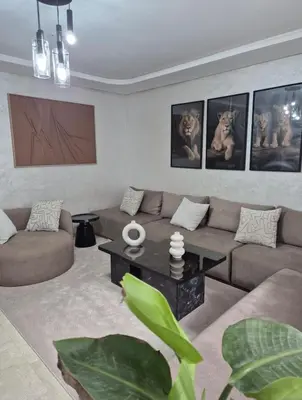 a living room with a couch and a coffee table at High standing 2 minutes from Gueliz train station in Marrakech