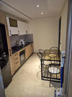 a small kitchen with a table and chairs in it at High standing 2 minutes from Gueliz train station in Marrakech
