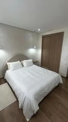 a bedroom with a large bed with white sheets at High standing 2 minutes from Gueliz train station in Marrakech