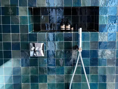 a blue tiled bathroom with a toothbrush and a camera at MIKESTAY - Villa Luma in Marrakech