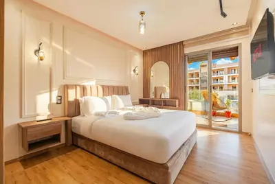 a bedroom with a large bed and a large window at Séjour luxueux pearl garden Marrakech in Marrakech