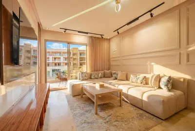 a living room with a couch and a table at Séjour luxueux pearl garden Marrakech in Marrakech