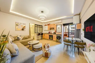 a living room with a couch and a table at Beautiful apartment in residence with pool in Marrakech