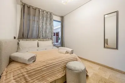 a bedroom with a large bed with a large window at Beautiful apartment in residence with pool in Marrakech