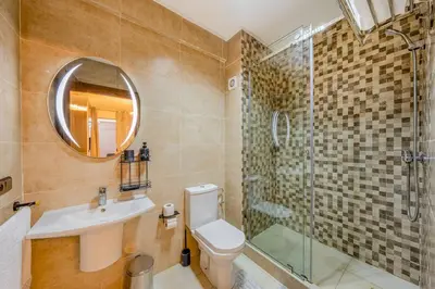 a bathroom with a toilet and a shower and a sink at Beautiful apartment in residence with pool in Marrakech