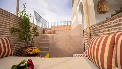a table with a bowl of bananas on a balcony at Riad Lala Fatima - New & Exclusive - Pool & Breakfast in Marrakech