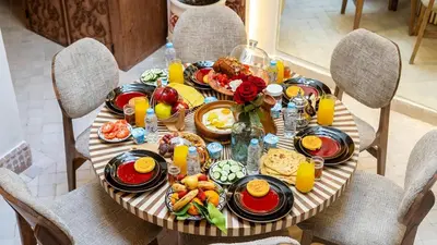 a table with breakfast foods and drinks on it at Riad Lala Fatima - New & Exclusive - Pool & Breakfast in Marrakech