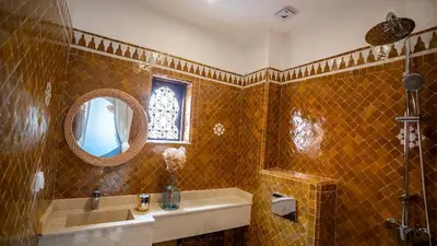a bathroom with a sink and a mirror at Riad Lala Fatima - New & Exclusive - Pool & Breakfast in Marrakech