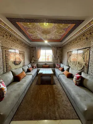 a living room with a large couch and a table at Apartment in Bassatine targa in Marrakech