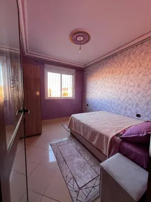 a bedroom with a bed and a window at Apartment in Bassatine targa in Marrakech