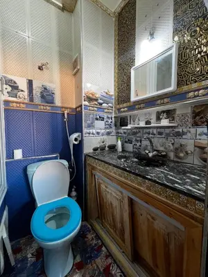 a bathroom with a blue toilet and a sink at Apartment in Bassatine targa in Marrakech