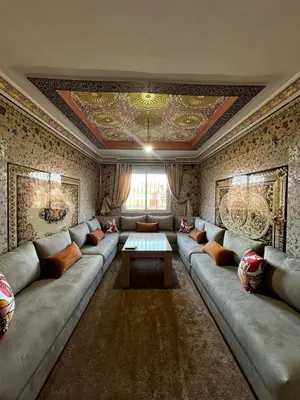 a living room with a large couch and a table at Apartment in Bassatine targa in Marrakech