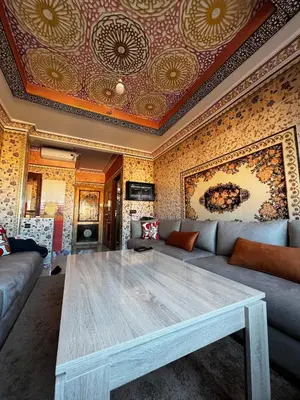 a living room with a couch and a table at Apartment in Bassatine targa in Marrakech