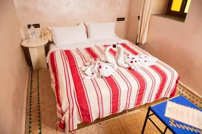 a bed in a room with two stuffed animals on it at Villa Dar Saada in Marrakech
