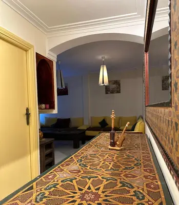 a living room with a table with a cross on it at مراكش كليز in Marrakech