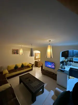 a living room with a couch and a tv at مراكش كليز in Marrakech