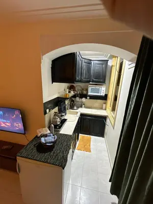 an overhead view of a small kitchen with black cabinets at مراكش كليز in Marrakech
