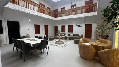 a living room with a table and chairs at Riad Dari and spa in Marrakech
