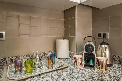 a kitchen counter with several cups on a counter top at Appartement familial 2 ch Wi-Fi 15 min centre in Marrakech