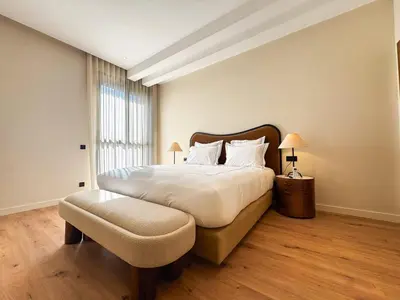 a bedroom with a large bed with a large window at 4-Suite Villa, Private Pool at Jade Garden in El Rhechat