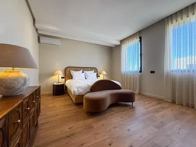 a bedroom with a bed and a table and a couch at 4-Suite Villa, Private Pool at Jade Garden in El Rhechat