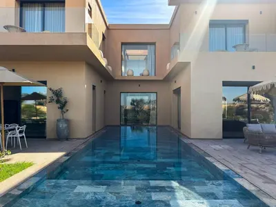 a swimming pool in the middle of a house at 4-Suite Villa, Private Pool at Jade Garden in El Rhechat