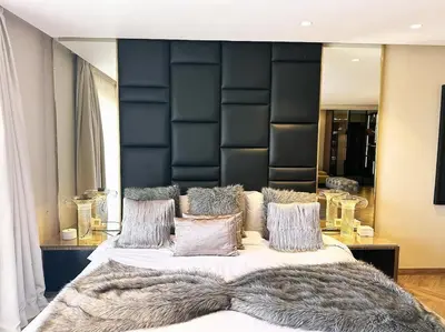 a bedroom with a large bed with a faux furussed headboard at Villa du Lac 4 suites in Prestigia in Marrakech