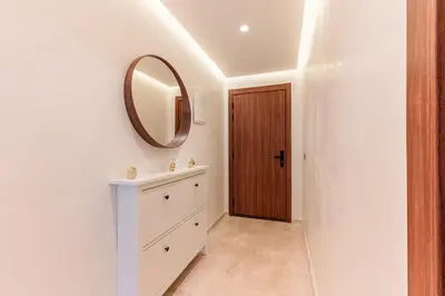 a white bathroom with a mirror and a dresser at Cocon Balnéo de Gueliz - Central & Balcon in Marrakech