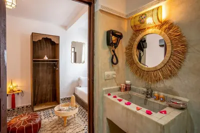 a bathroom with a sink and a mirror at Riad Nowara And Spa in Marrakech