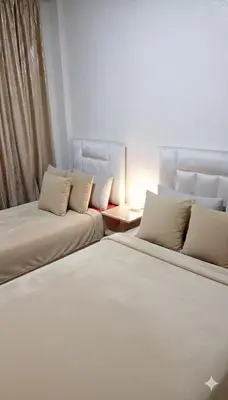 two beds sitting next to each other in a room at Au Coeur de L'hivernage P21 in Marrakech