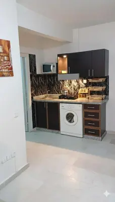 a kitchen with a washing machine in a room at Au Coeur de L'hivernage P21 in Marrakech
