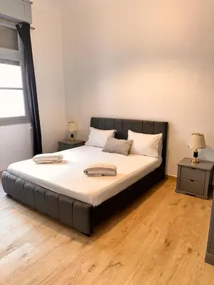 a large bed in a room with two night stands at Studio Mhamid 10 in Marrakech