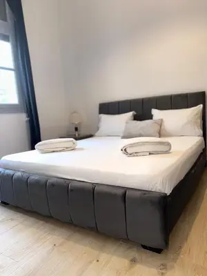 a large bed with a black headboard in a bedroom at Studio Mhamid 10 in Marrakech