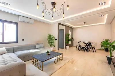 a living room with a couch and a table at Apartment in the heart of Marrakech - 2BR in Marrakech