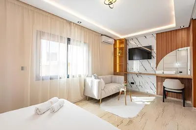 a bedroom with a bed and a living room at Apartment in the heart of Marrakech - 2BR in Marrakech