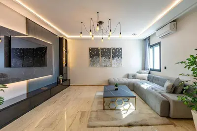 a living room with a couch and a tv at Apartment in the heart of Marrakech - 2BR in Marrakech