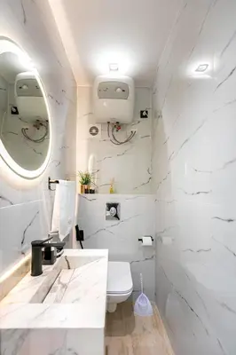 a white bathroom with a sink and a toilet at Apartment in the heart of Marrakech - 2BR in Marrakech