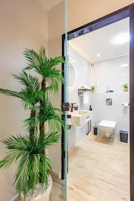 a bathroom with a palm tree next to a toilet at Apartment in the heart of Marrakech - 2BR in Marrakech