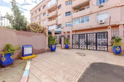 a parking lot in front of a building at Zou Appartement in Marrakech