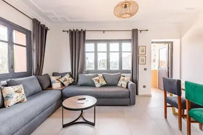a living room with a couch and a table at Zou Appartement in Marrakech