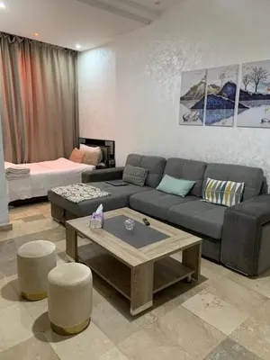 a living room with a couch and a coffee table at Studio moderne et calme à Guéliz in Marrakech