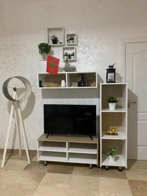 a living room with a television on a white entertainment center at Studio moderne et calme à Guéliz in Marrakech