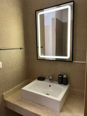 a white sink in a bathroom with a mirror at Apartment with swimming pool full air-conditioned in Marrakech