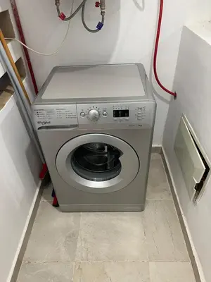a washing machine in a corner of a room at Apartment with swimming pool full air-conditioned in Marrakech