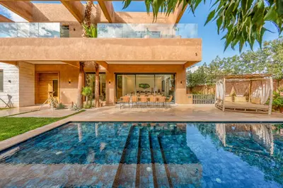 an exterior view of a house with a swimming pool at Sublime Villa in Agdal Elevator with heated pool in Marrakech