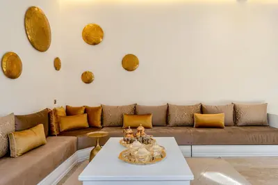 a living room with a couch and a table at Sublime Villa in Agdal Elevator with heated pool in Marrakech