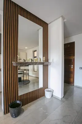 a hallway with a mirror and a dining room at Appart chic et calme avec vue dégagée in Marrakech