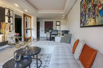 a living room with a couch and a table at Appart chic et calme avec vue dégagée in Marrakech