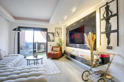 a living room with a couch and a table at Appart chic et calme avec vue dégagée in Marrakech